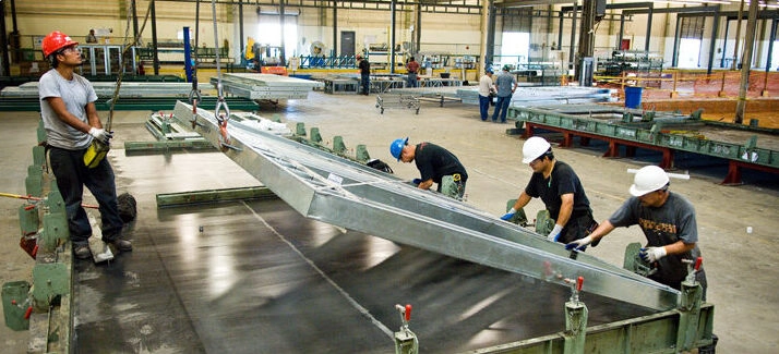 a group of workers working in a factory the steel Framing